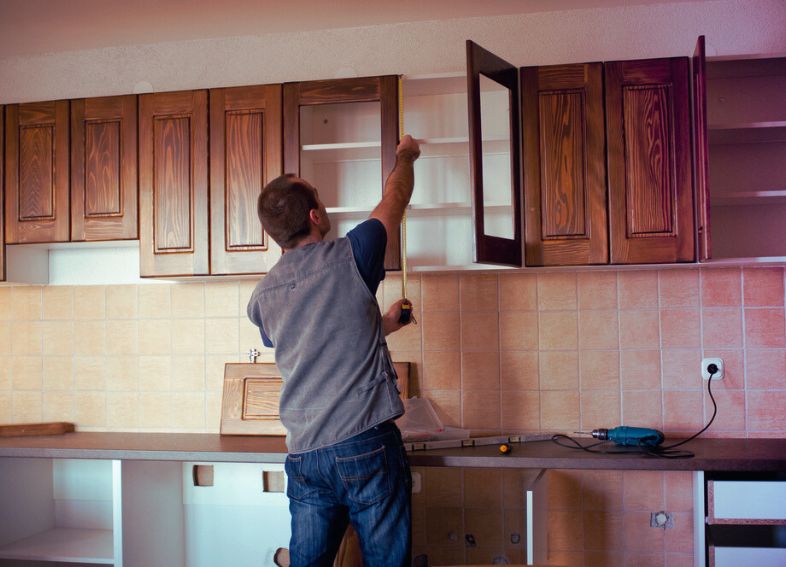 Carpenter working on kitchen Cabinets 