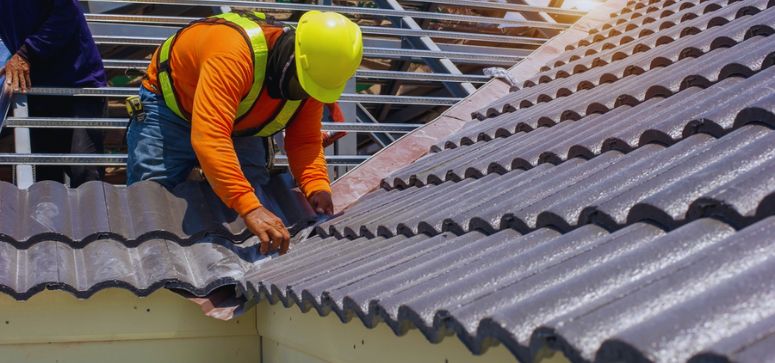 Roof worker repairing