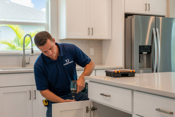 Kitchen remodeling contractors from TJ Handyman Services working on cabinet installation in a modern Orlando kitchen, delivering expert renovation services.