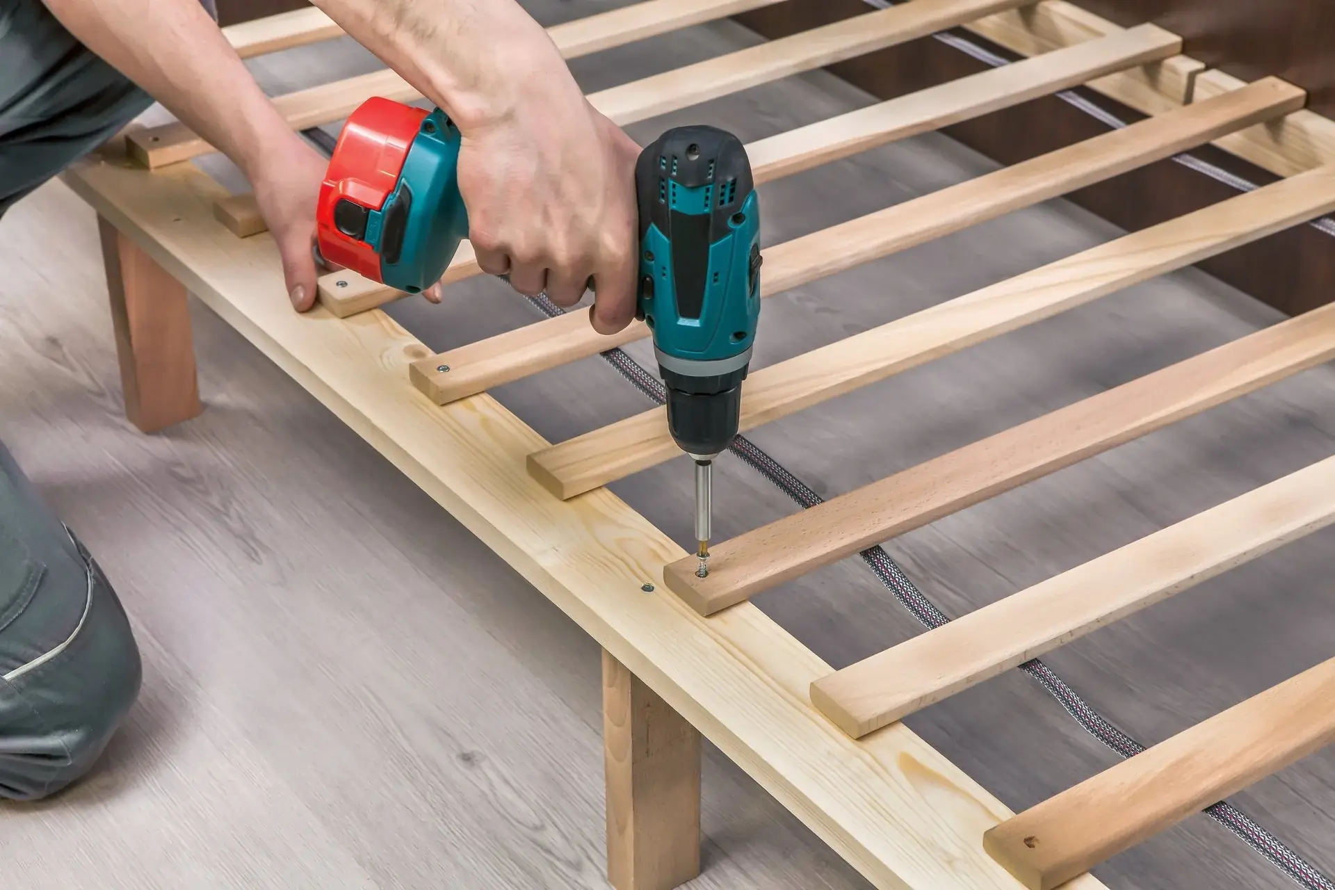 A man is assembling furniture with his drill machine in winter park fl