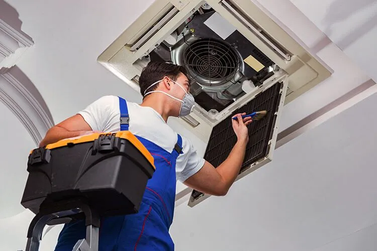 A man is repairing the AC