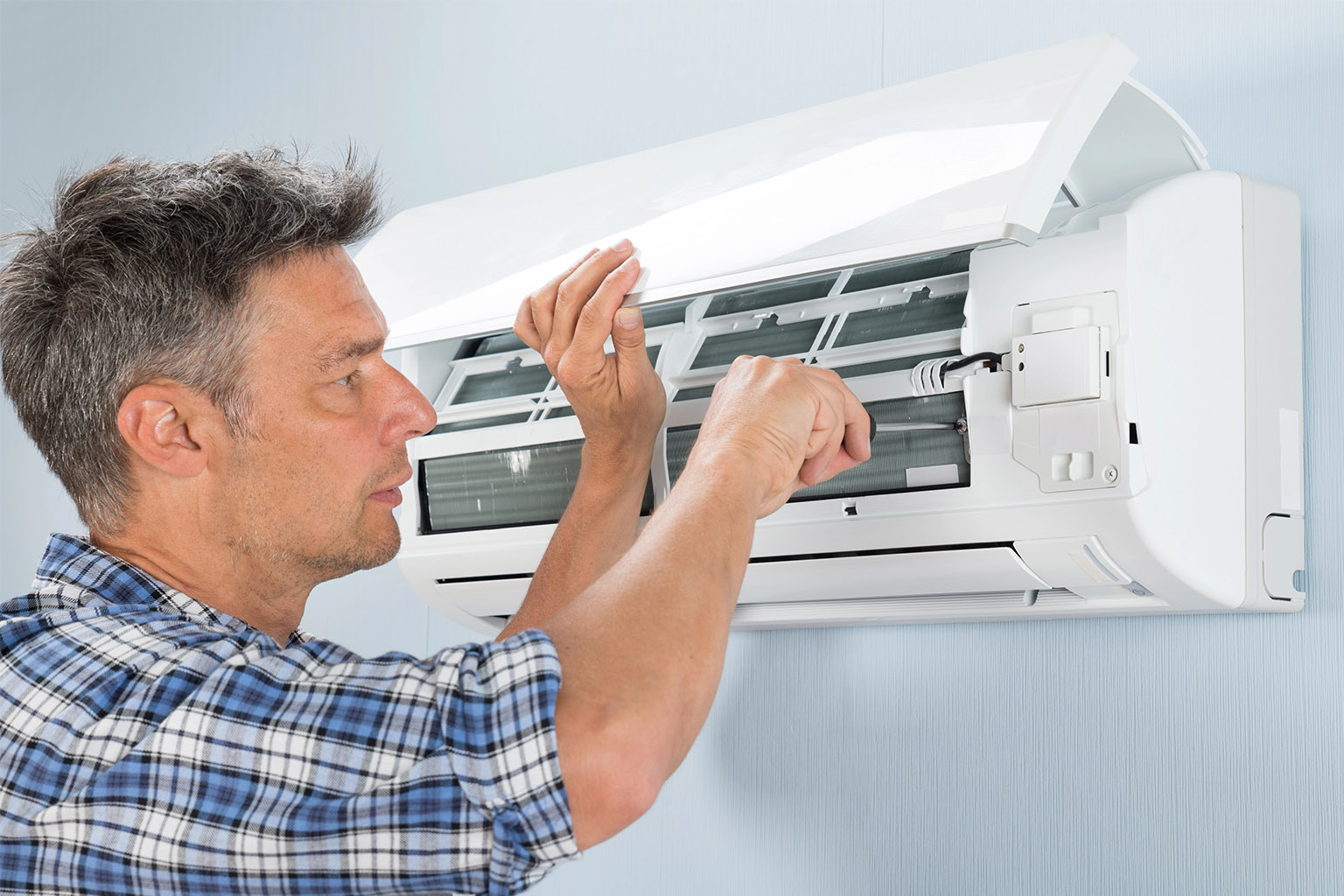a man is repairing split ac