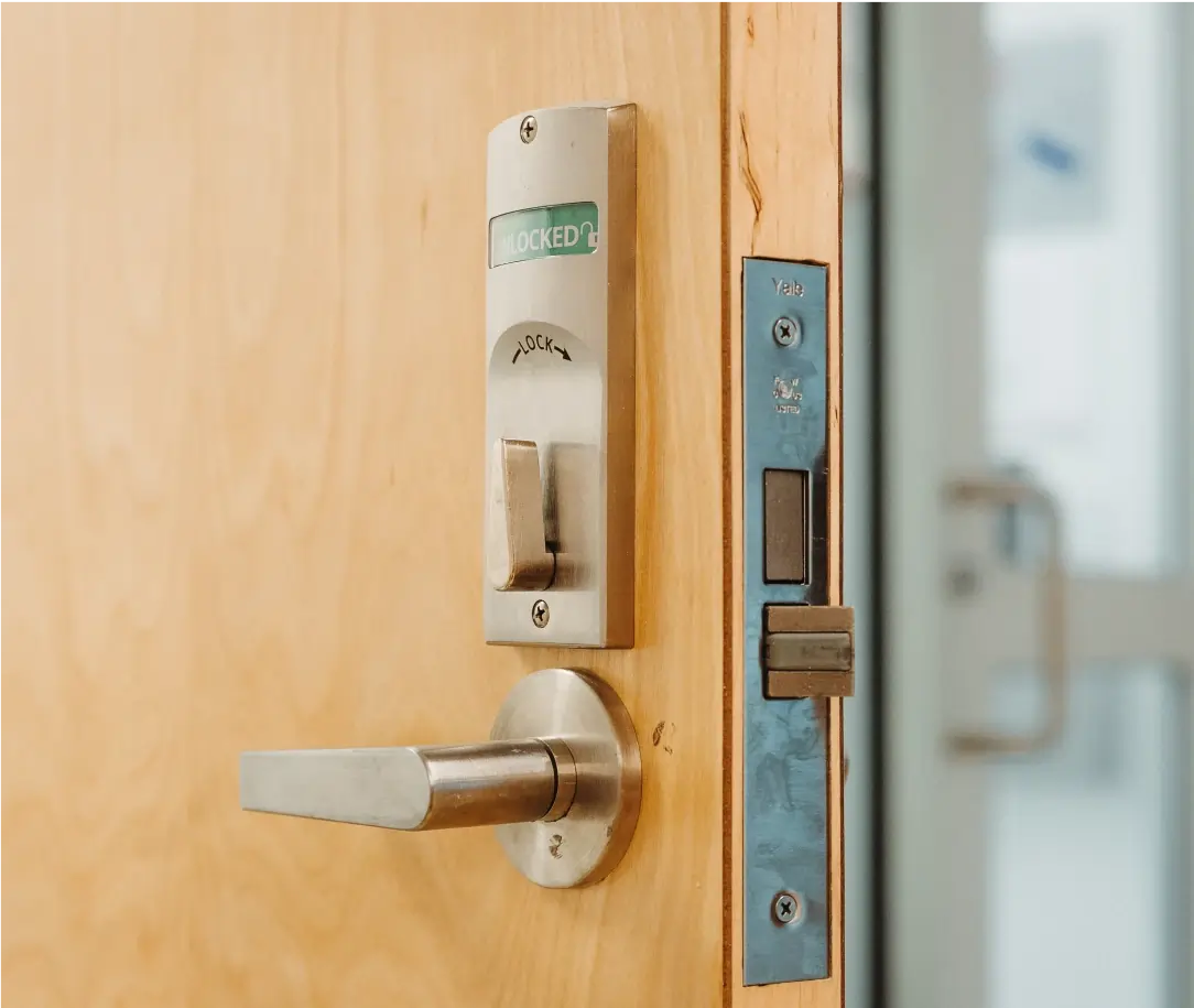 Lock and other hardware is being installed on a door.