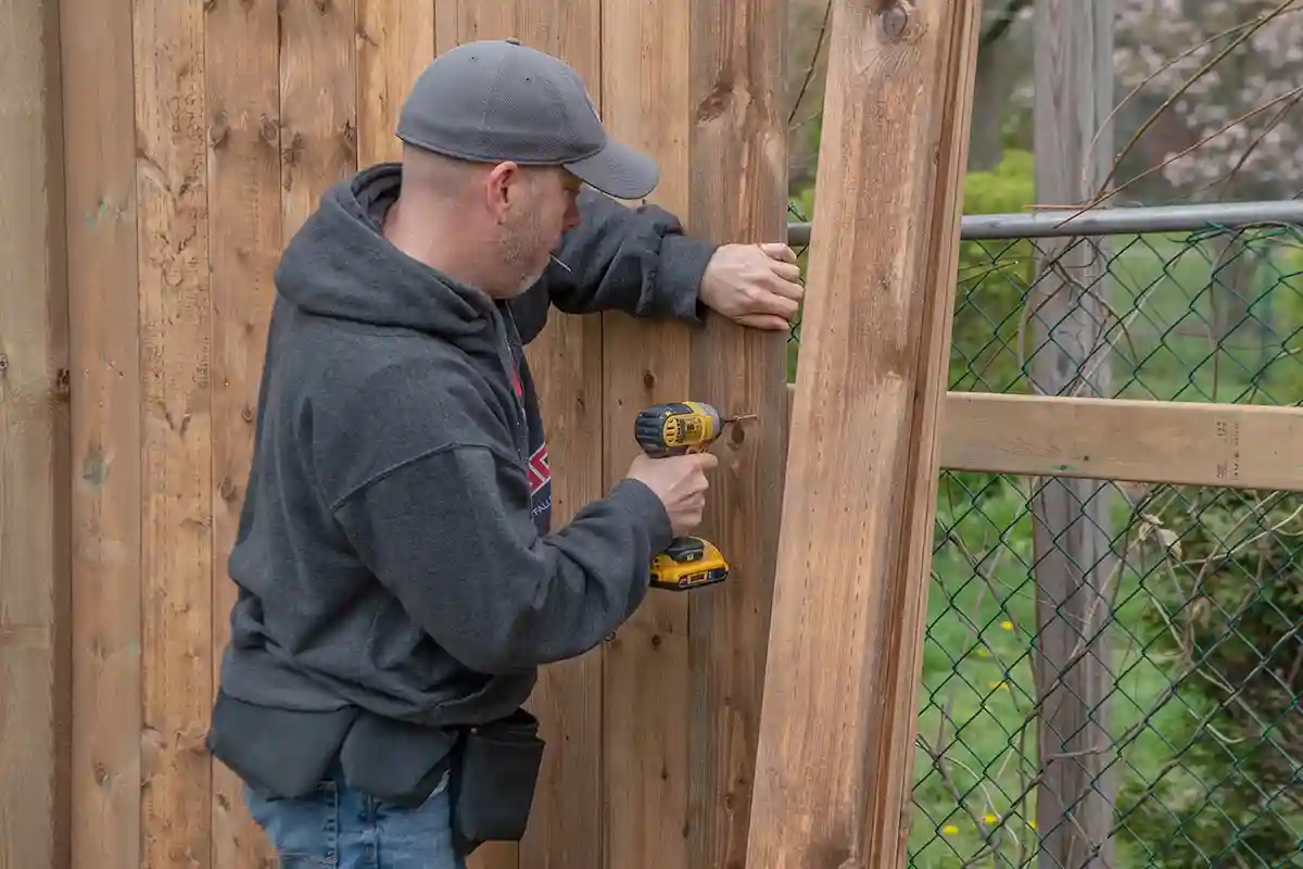 a man is installing fence