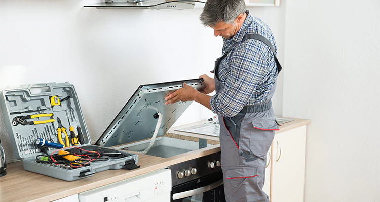 a man is installing a kitchen appliance
