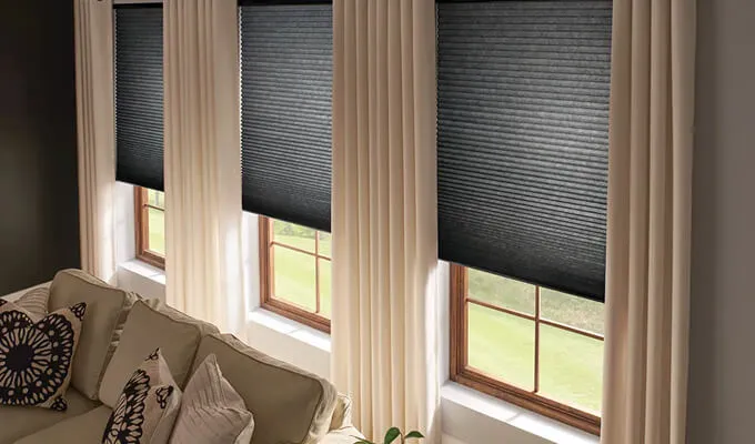 TJ Handyman Services curtain and blinds installation showing dark window blinds and floor-length curtains in an Orlando living room.